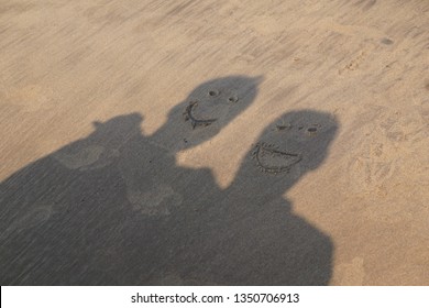 Funny And Happy People Shadow With Smiley Faces, Friends Funny Faces Shadow Made At Beach, Beach Sand Funny Face Shadows