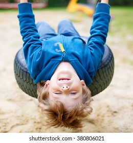 Funny Happy Preschool Kid Boy Having Fun Chain Swing On Outdoor Playground. Child Swinging On Warm Sunny Summer Day. Active Leisure With Kids. Family, Lifestyle, Summer Concept