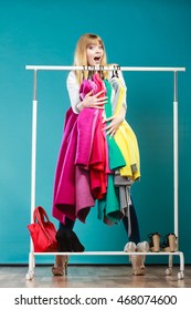 Funny Happy Woman Girl Taking Grabbing All Clothes Coats And Shirts In Wardrobe. Young Girl Shopping In Mall. Fashion Clothing Sale Concept.