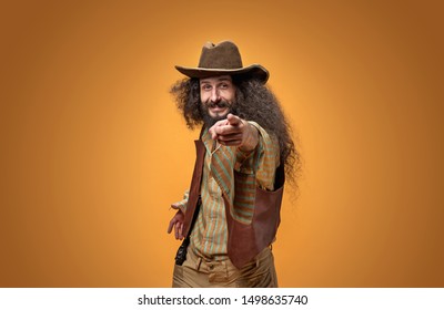 Funny Hipster Cowboy On Orange Studio Background