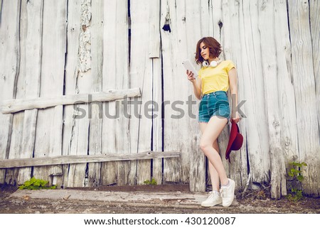 Funny Hipster Girl over white old wooden wall, hipster outfit Going Crazy at tropical island.Trendy Casual Fashion Outfit in summer,spring.Toned Photo,Copy Space.