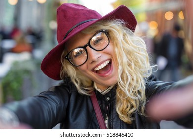 Funny hipster woman taking selfie