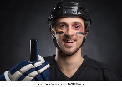 Funny Hockey Player Smiling With One Tooth Missing. Isolated On Black 