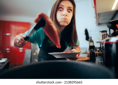 
Funny Home Cook Preparing a Tuna Steak at Home. Concerned woman trying to make a seafood dish having problems pan searing it
