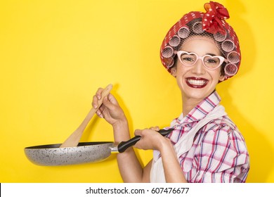 Funny Housewife Cooking On Yellow Background