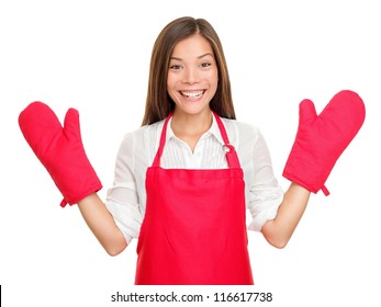 Funny housewife woman with oven mittens and red apron isolated on white background. Beautiful smiling excited mixed-race Caucasian / Asian Chinese young woman. - Powered by Shutterstock