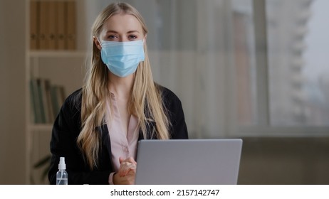 Funny Humorous Business Woman Worker In Office Sitting At Table Feels Cold Suffering From Flu Virus Puts On Three Protective Medical Face Masks Fear Of Contracting Coronavirus Pandemic Safety Rules