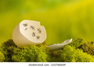 Funny image of a white chicken egg with a tally sign calendar inside - Shutterstock ID 2137360439