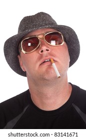 A funny image of a young man wearing a hat with his head tilted back.  He has a cigarette hanging out of his mouth.