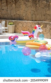 Funny Inflatable Unicorn Ring Floating In Swimming Pool On Sunny Day. Swimming Pool Party Concept.No People.