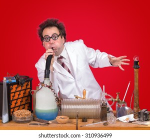 Funny Inventor Working In Laboratory With Experiment. Genius Professor Taught At School. Mad Scientist Makes An Invention In His Retro Lab.. 