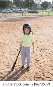 Funny Kid Baseball Player In Baseball Helmet And Baseball Bat.