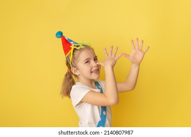 Funny Kid Clown Against Yellow Background. Happy Child Playing With Festive Decor. Birthday And 1 April Fool's Day Concept.