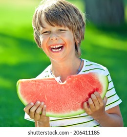 Funny Kid Eating Watermelon Outdoors In Summer Park. Child, Baby, Healthy Food