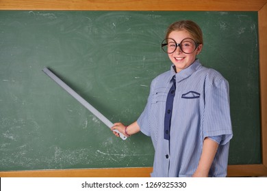 Funny Kid Girl With Teacher Costume In Green Blackboard With School Ruller