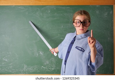 Funny Kid Girl With Teacher Costume In Green Blackboard With School Ruller