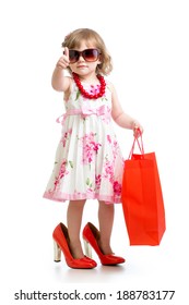 Funny Kid Girl Trying On Her Mom's Red Accessories And Shoes