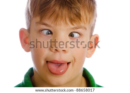 Funny kid with a silly expression on his face.