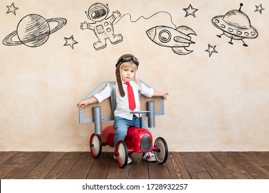 Funny kid with toy jet pack. Happy child playing at home. Success, imagination and innovation technology concept - Shutterstock ID 1728932257