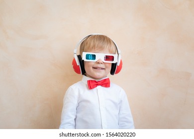 Funny kid wearing 3d glasses. Happy child having fun at home. Retro cinema concept