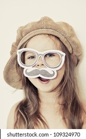 Funny Kid Wearing A Fake Mustache And Cap