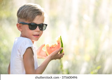 Funny Kid Wearing Sunglasses Eat Watermelon On A Sunny Summer Day