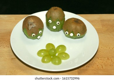 funny kids food three stooges made of kiwi on a white plate