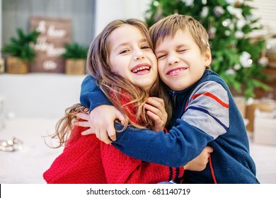 Funny Kids Are Hugging. The Boy And The Girl. Happy Christmas And New Year Concept.