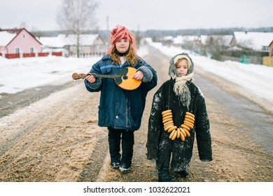 Funny Kids Outdoor. Youth In Village. Russian Style Traditional Clothes. Two Little Girls Bizarre Unusual Strange Portrait. Children Wearing Adult Oversized Clothing. Traditions In Country. Childhood