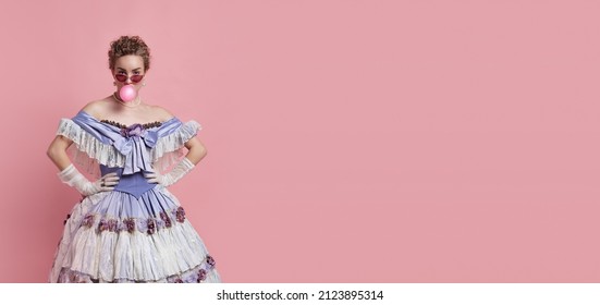 Funny lady. Vintage portrait of young adorable girl in image of medieval royal person in renaissance style dress isolated on pink background. Comparison of eras, beauty, history, art, creativity.