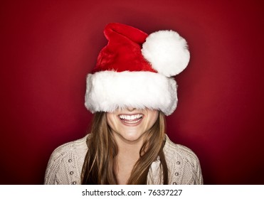 Funny Laughing Christmas Girl With Red Fluffy Santa Hat