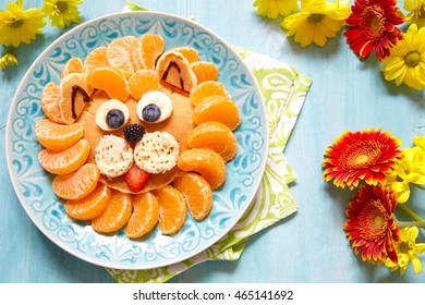 Funny lion pancake with mandarins and berries