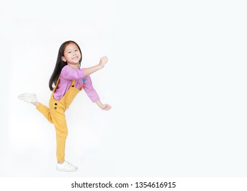 Funny little Asian child girl isolated on white background with copy space. Happy and smiling shot.