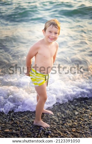 Similar – Cute little boy toaching the water with his feet.