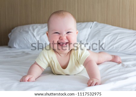 Similar – Der kleine Junge lächelt im Bett in seinem eigenen Zimmer.