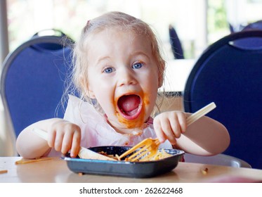 Funny Little Blond Girl Eating Pasta And Making A Mess 