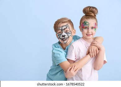 Funny little children with face painting on color background - Powered by Shutterstock