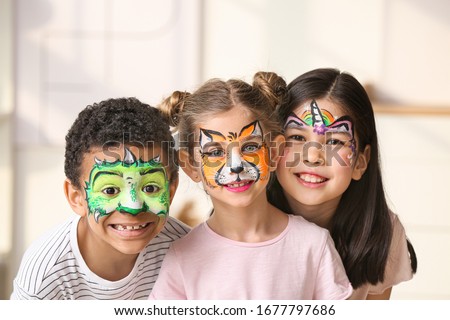 Funny little children with face painting at home
