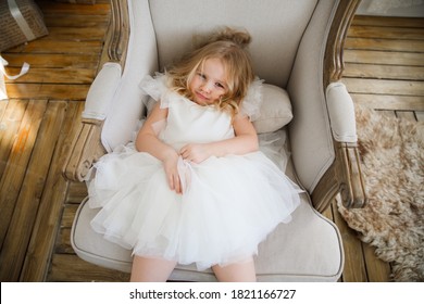 Funny Little Girl Does Not Want To Be Photographed. Naughty, Spoiled Child. Problems At A Photo Shoot With Children.