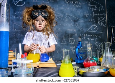 Funny little girl doing experiments in the laboratory. Explosion in the laboratory. Science and education. - Shutterstock ID 627551969