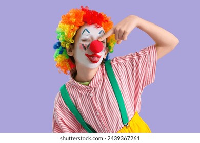 Funny little girl dressed as clown on lilac background, closeup. April Fools' Day celebration - Powered by Shutterstock