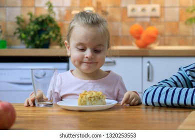 Funny Little Girl Eating Apple Pie At Home