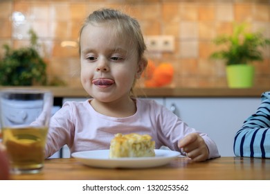 Funny Little Girl Eating Apple Pie At Home