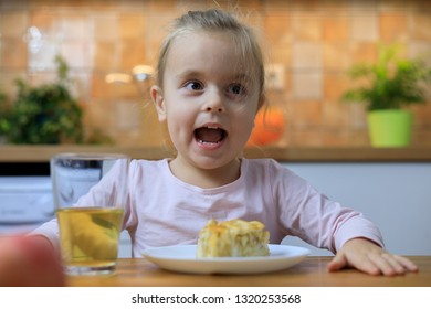 Funny Little Girl Eating Apple Pie At Home