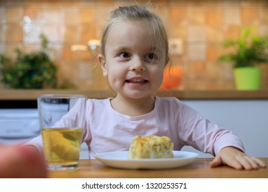 Funny Little Girl Eating Apple Pie At Home