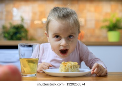 Funny Little Girl Eating Apple Pie At Home