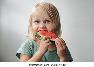 Funny Little Girl Eating Watermelon Close-up. Cute Child With Watermelon Indoors. Concept Of Healthy Food, Summertime. Copy Space