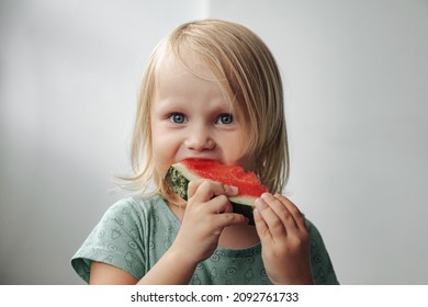 Funny Little Girl Eating Watermelon Close-up. Cute Child With Watermelon Indoors. Concept Of Healthy Food, Summertime. Copy Space