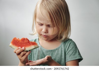 Funny Little Girl Eating Watermelon Close-up. Cute Child With Watermelon Indoors. Concept Of Healthy Food, Summertime. Copy Space