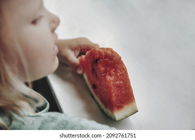 Funny Little Girl Eating Watermelon Close-up. Cute Child With Watermelon Indoors. Concept Of Healthy Food, Summertime. Copy Space